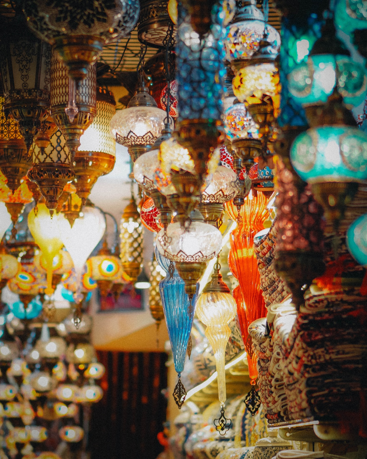 Hanging mosaic glass lanterns glowing in a Turkish bazaar
